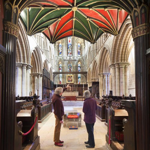 Image of two people in the nave of an abbey