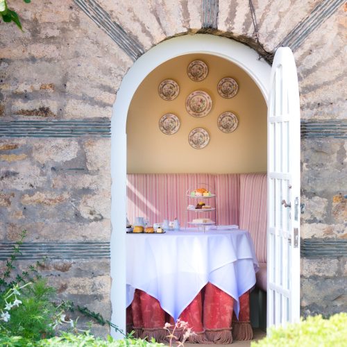 Image of a door opening into a room set for tea